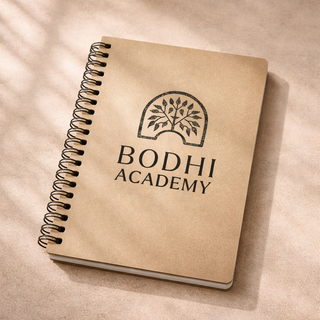 Custom education brand logo for Bodhi Academy displayed on notebook featuring tree symbol and minimalist typography