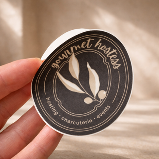 Custom charcuterie brand logo sticker for Gourmet Hostess featuring elegant circular design and botanical illustration