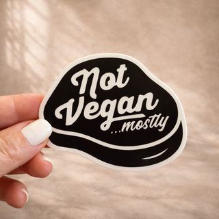 Food truck logo design sticker for Not Vegan Mostly featuring custom script typography and bold black and white branding