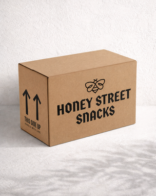 Custom printed corrugated kraft shipping box for Honey Street Snacks branded ecommerce packaging, sustainable cardboard shipper boxes, and premium custom food packaging design.