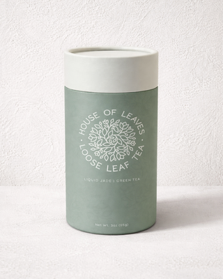 Sage green loose leaf tea tube with white botanical logo and typography.